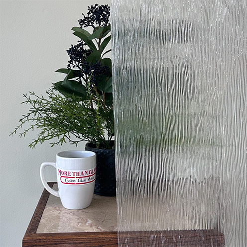 Clear Cord Cabinet Door Glass With Vertical Line Texture And Plant Behind – More Than Glass