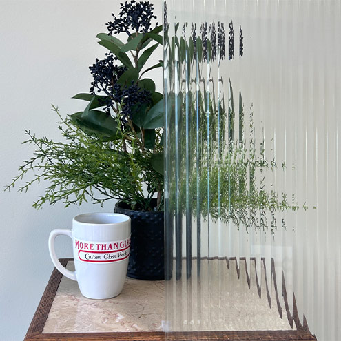 Reeded Cabinet Door Glass With Vertical Ribbed Texture And Plant Behind – More Than Glass
